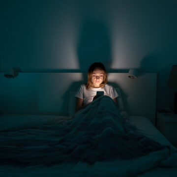 Person stressed out while scrolling through negative news — how to stop doom scrolling habits
