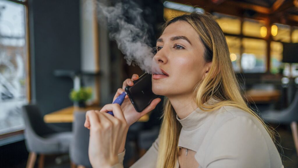 A young girl vaping 
