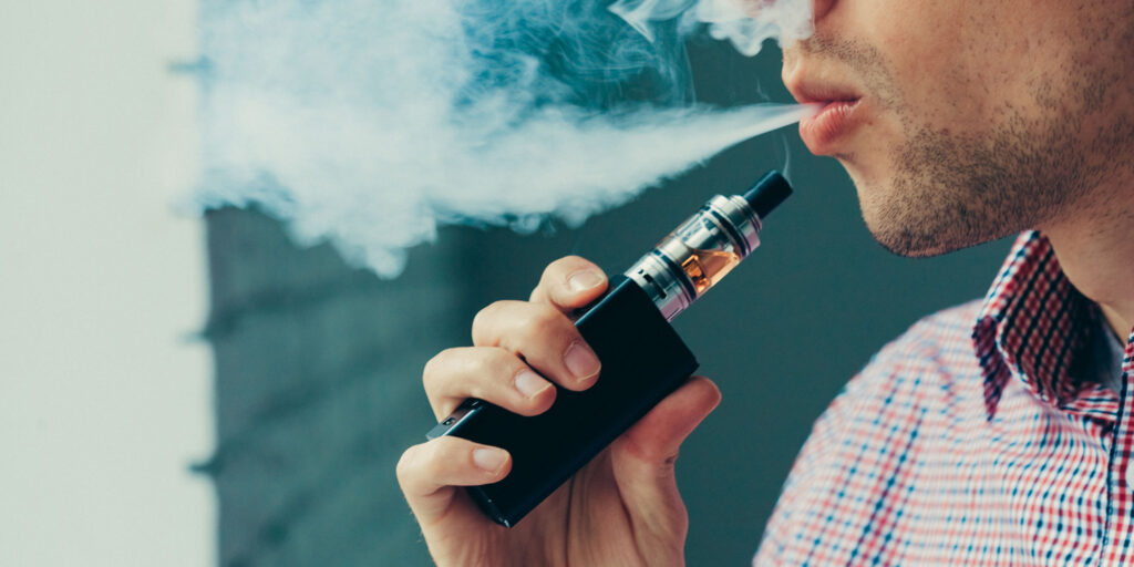 A young man vaping