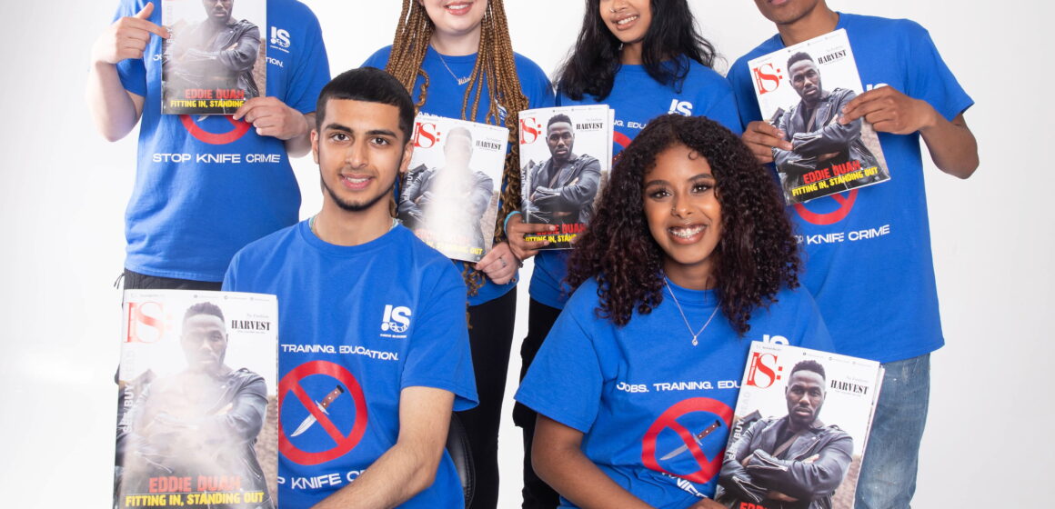 A picture of some of the young people who work at inside success union c.i.c holding the maagzine