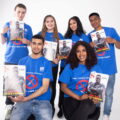 A picture of some of the young people who work at inside success union c.i.c holding the maagzine