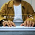 A person googling for jobs online as part of their job search