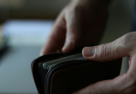 Man opening his wallet with cash in.