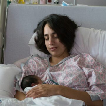Woman with new born baby in the maternity ward. Photo Credit: Brian Wangenheim on Unsplash
