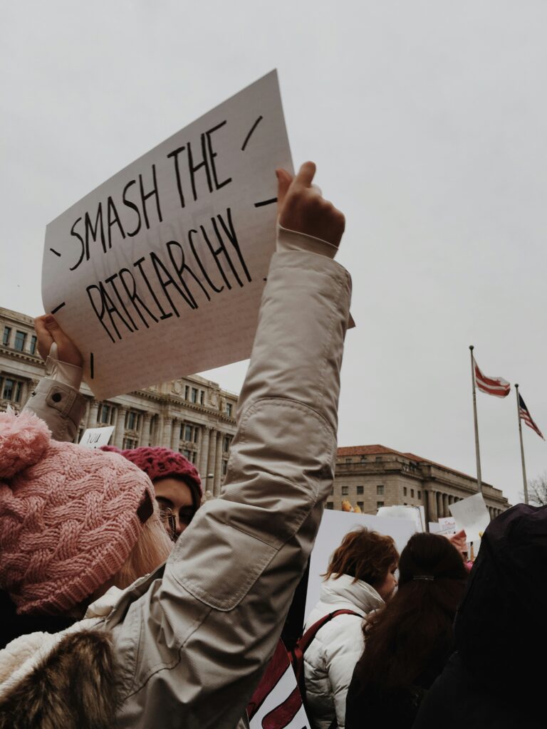 Woman holding an anti-patriarchy sign at a march.