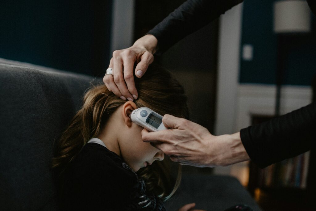 Girl having her temperature checked. Photo Credit: Kelly Sikkema on Unsplash