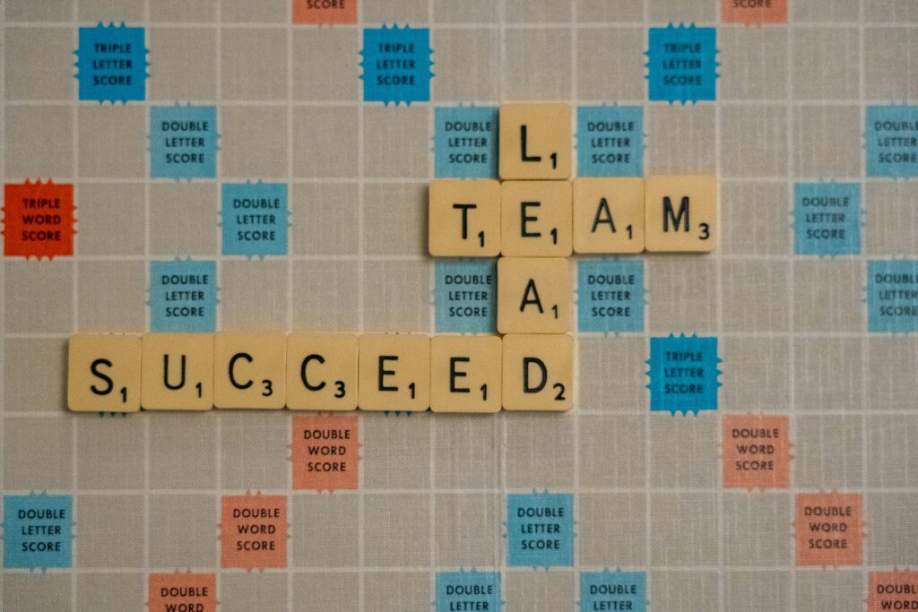 Photo of a scrabble board with the words 'Lead,' 'Team' and 'Success' displayed.