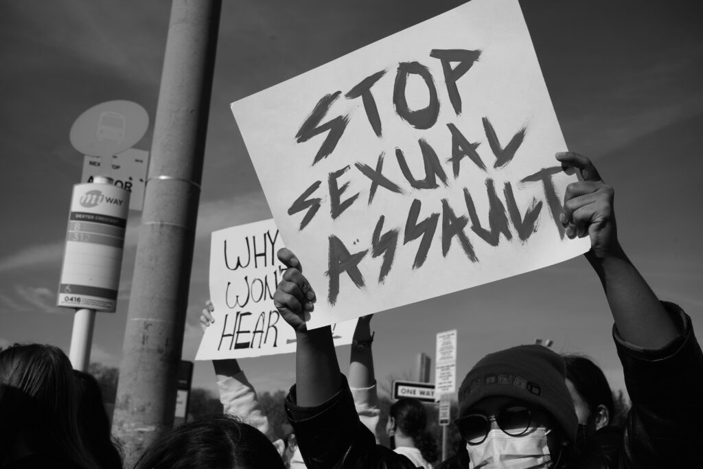 Photo of people holding signs as at anti sexual assault march 