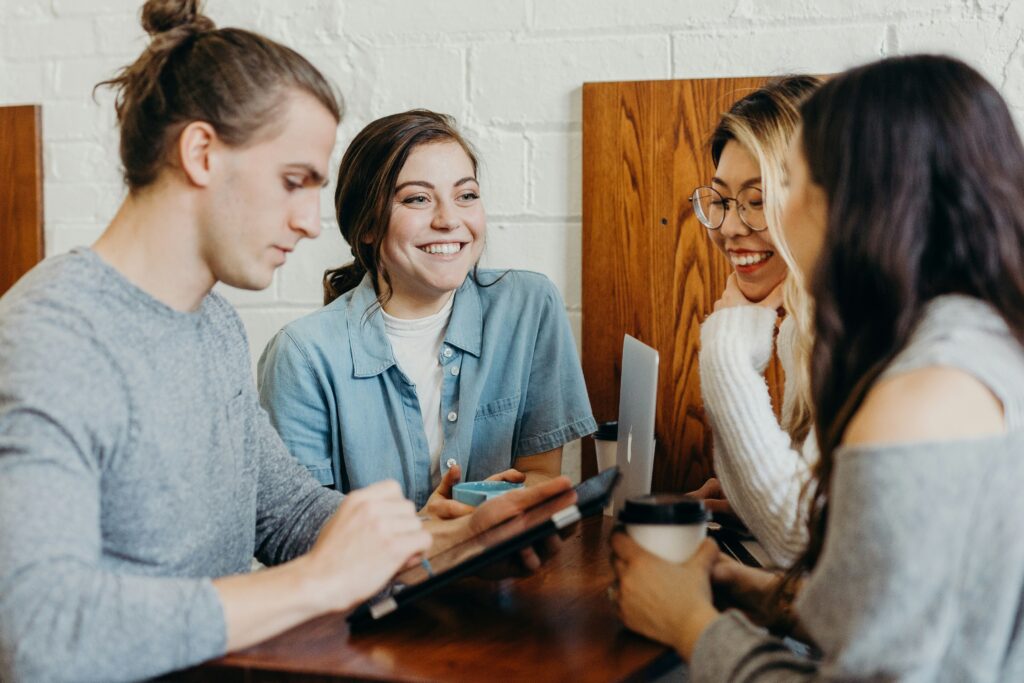 Photo of young people socialising at a work event. Photo Credit: Brooke Cagle on Unsplash