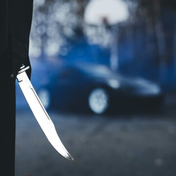 Photo of someone holding a knife as a weapon