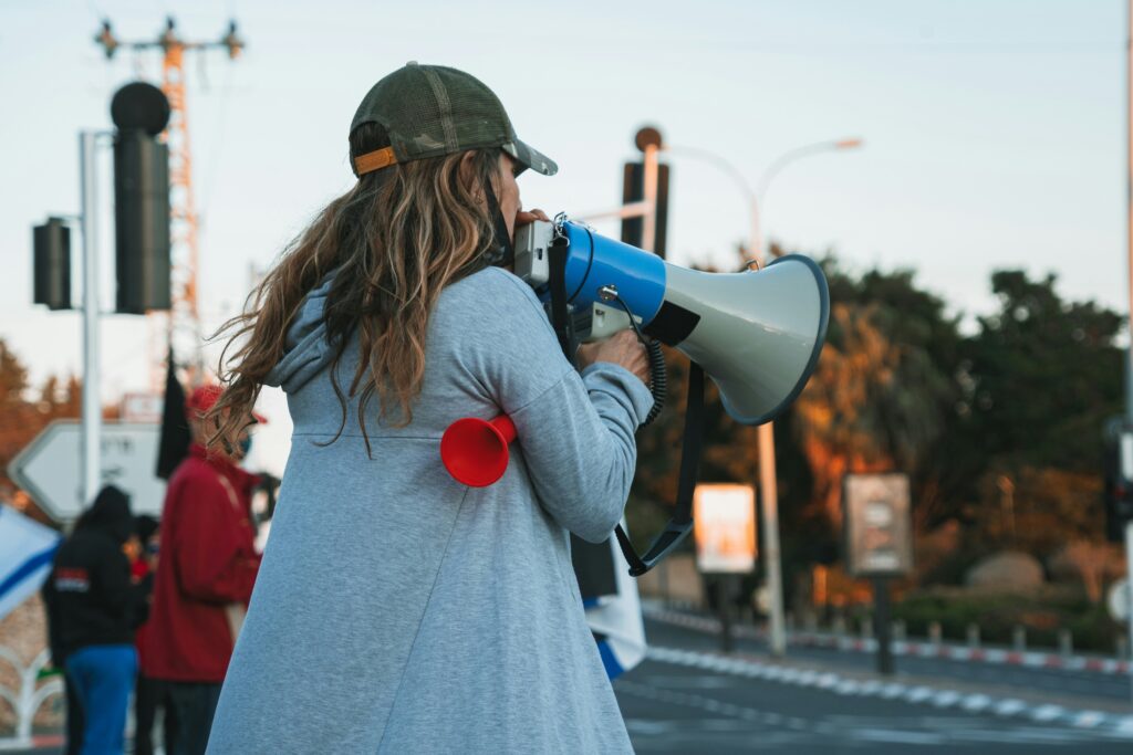 Photo of someone with a mega phone at a strike