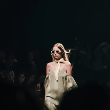 Photo of a fashion model walking a runway.