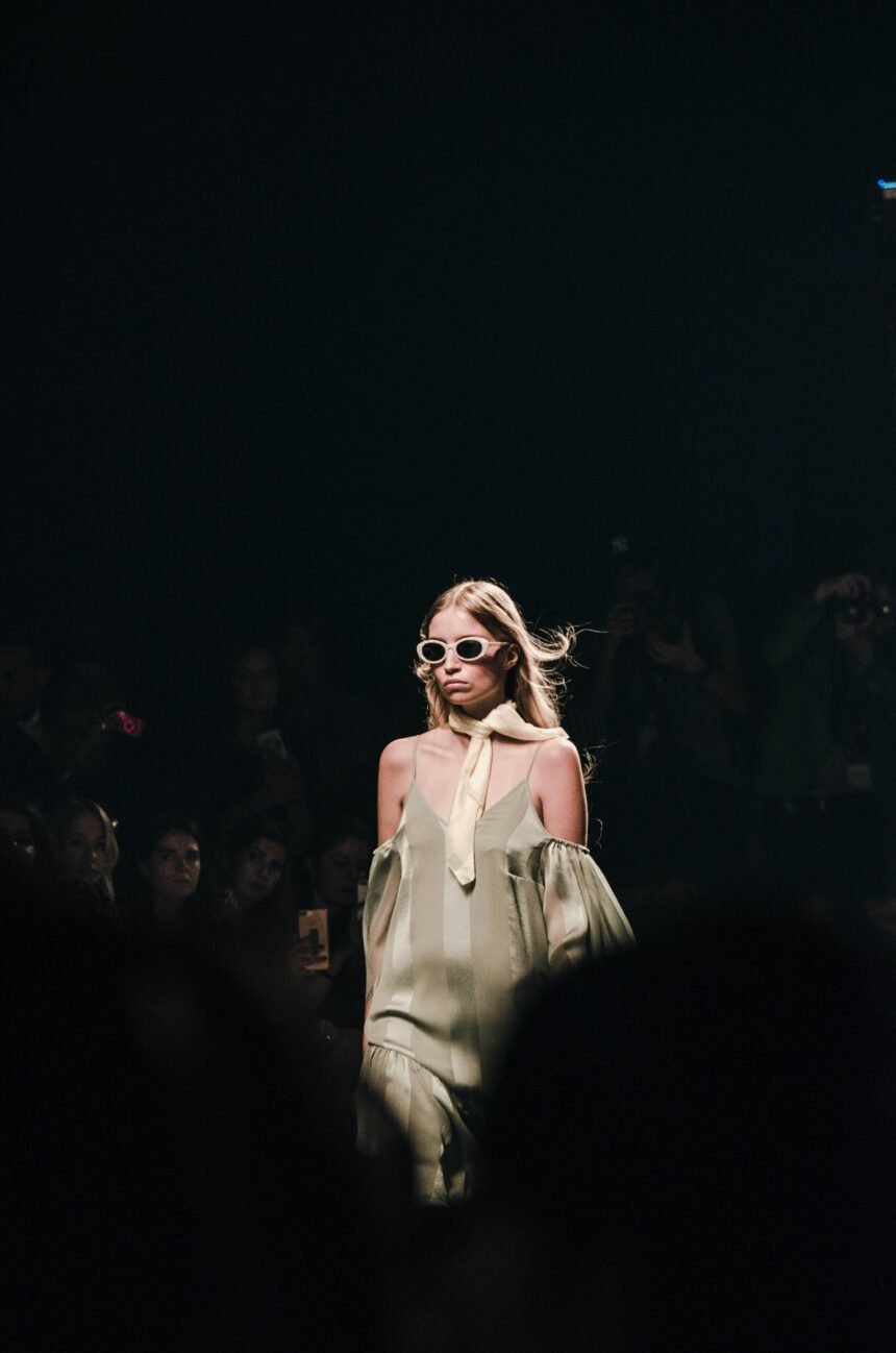 Photo of a fashion model walking a runway.