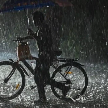 People struggling with umbrellas in torrential rain and gale-force gusts