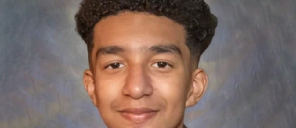 A lonely teenager sitting in the dark with a glowing phone screen — AI chatbot dangers for youth and emotional attachment risks