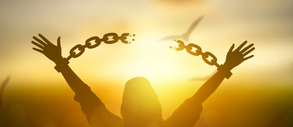 Person breaking free from chains — symbolizing the choice to let go of the 10-year plan and embrace personal freedom